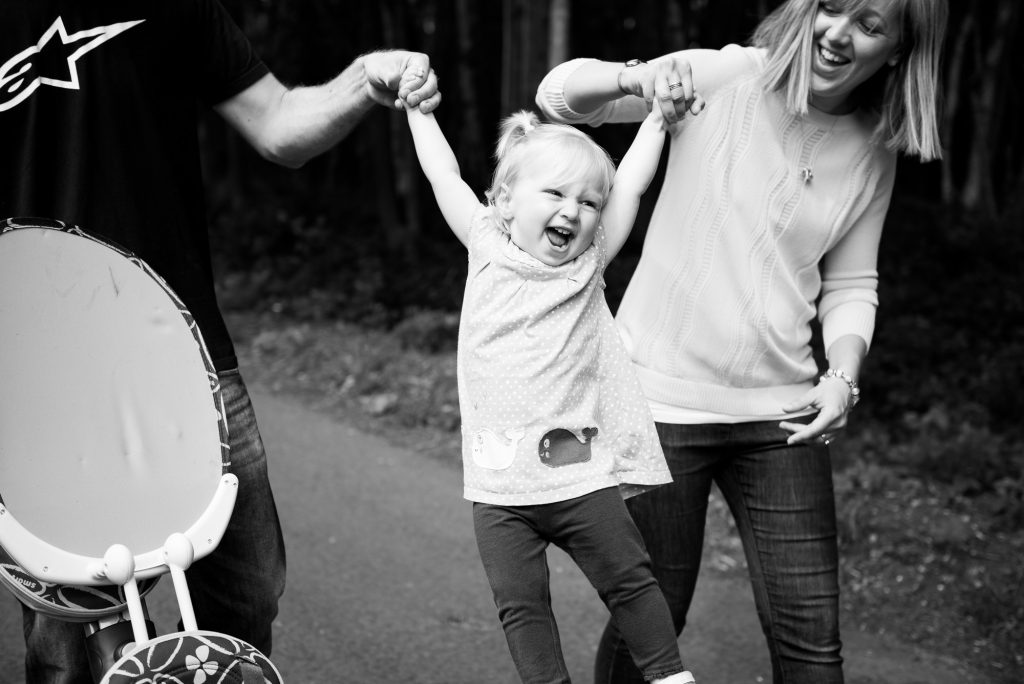 Parents lift daughter happy moment