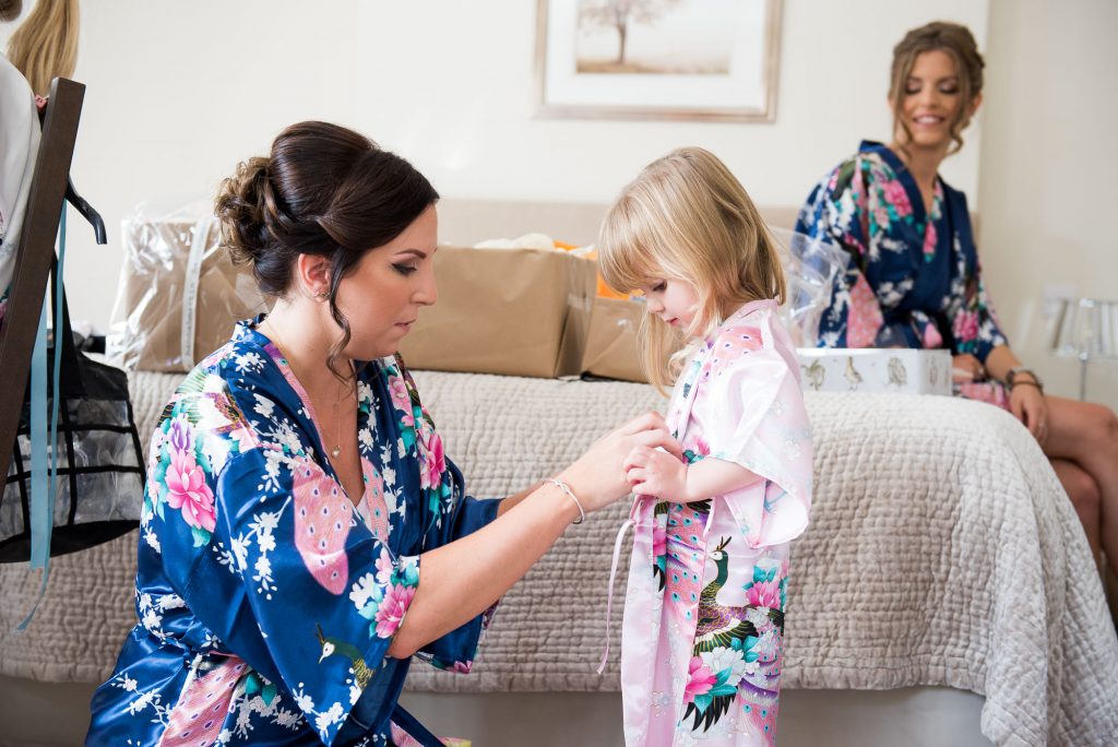 Bridesmaid with flower girl wearing floral robes pre wedding photography