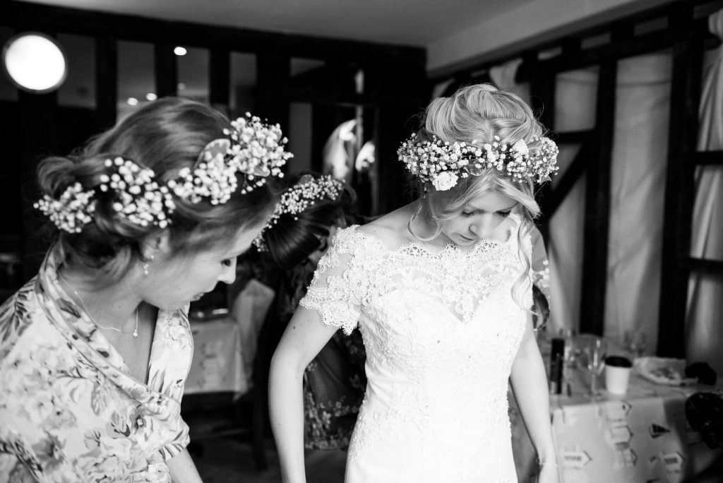 Bride wearing lace dress with boho floral crown Cornwall