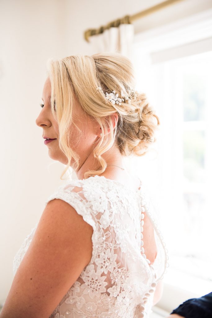 Elegant bridal hair by Lucy Alexander with flower detail
