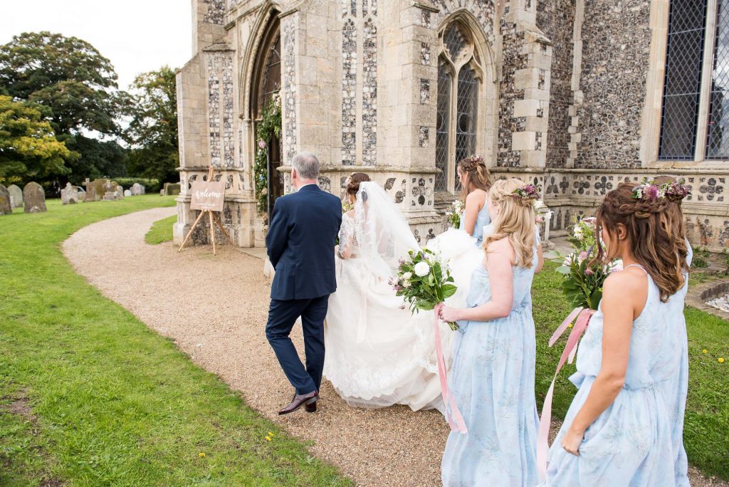 Bride with father walking to church Norfolk