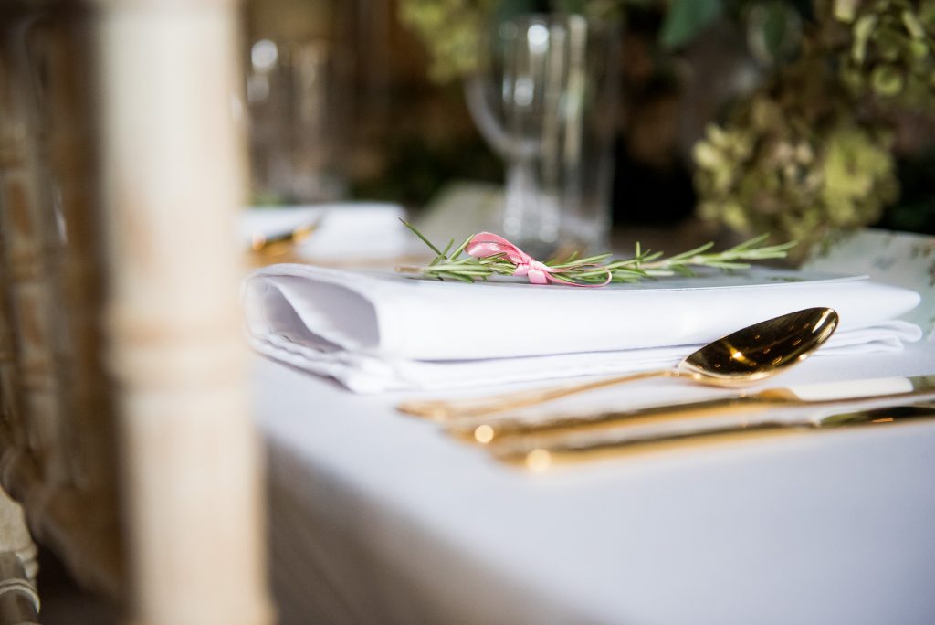 Gold cutlery with rosemary wedding table decor Spixworth Hall Wedding