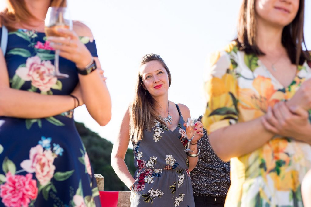 Wedding guests wearing floral dresses summer outdoor Cornwall wedding 