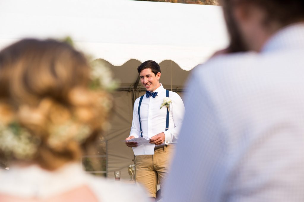 Groomsmen delivers speech outdoor Cornwall wedding