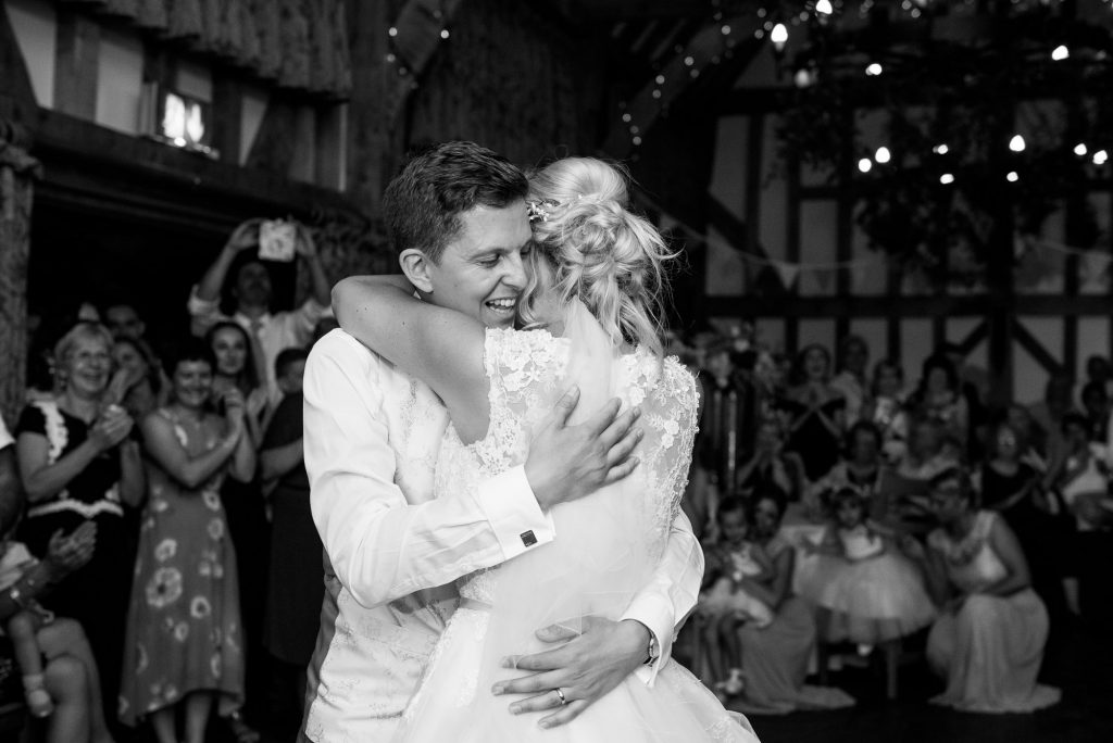 Groom with bride hug after first dance 