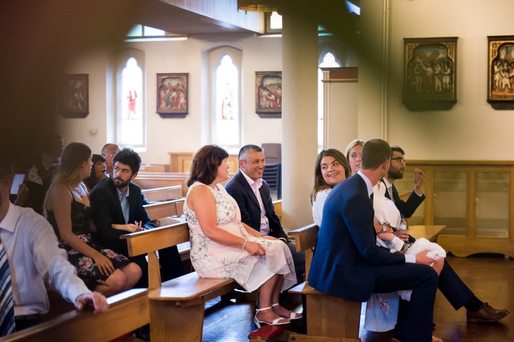 Family gather for babys christening in a Chelmsford church