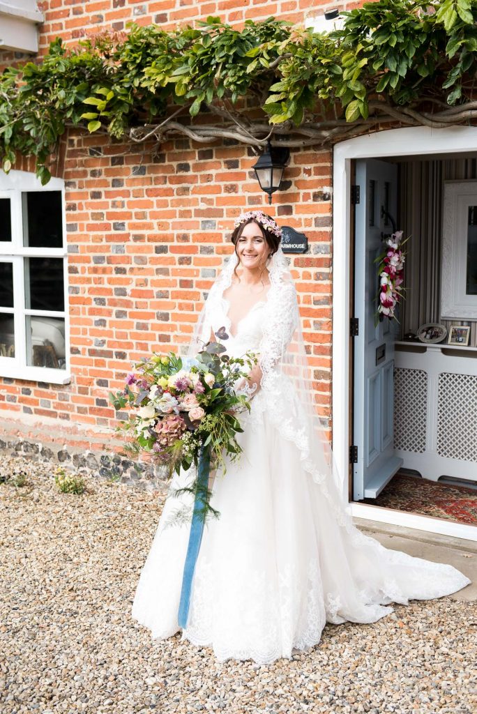 Jay West bride with cathedral length veil and flower crow, Norfolk Barn Wedding