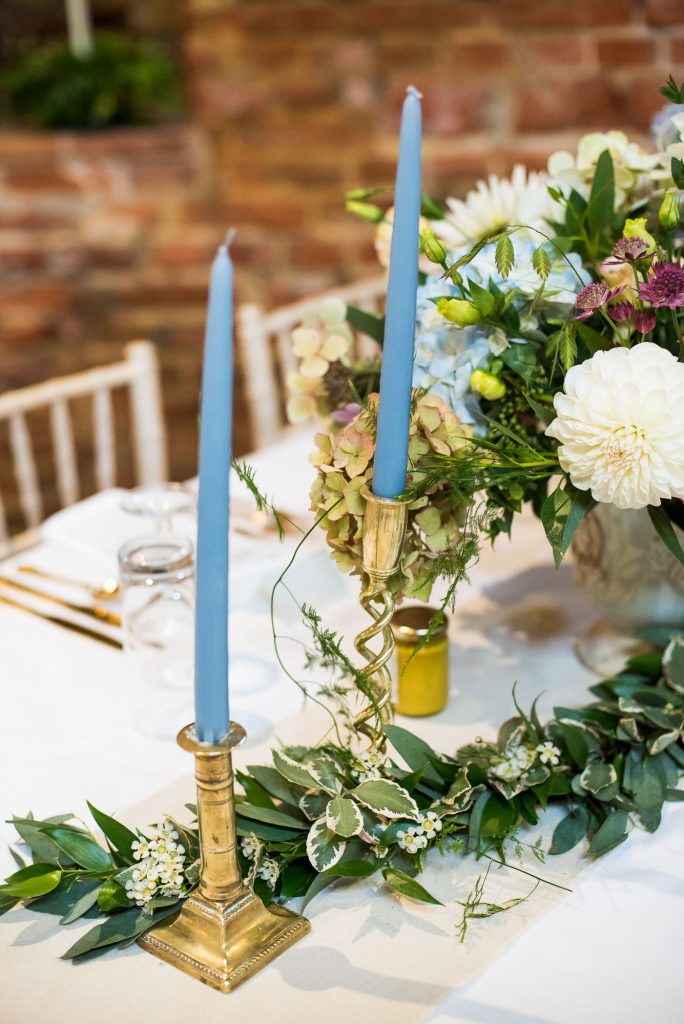 Vintage candle sticks with light blue candles for wedding barn decor