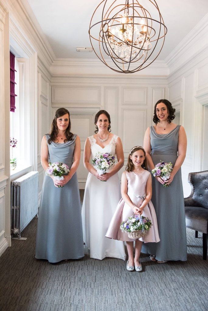 Elegant bride and bridesmaids in pastel blue dresses Surrey wedding
