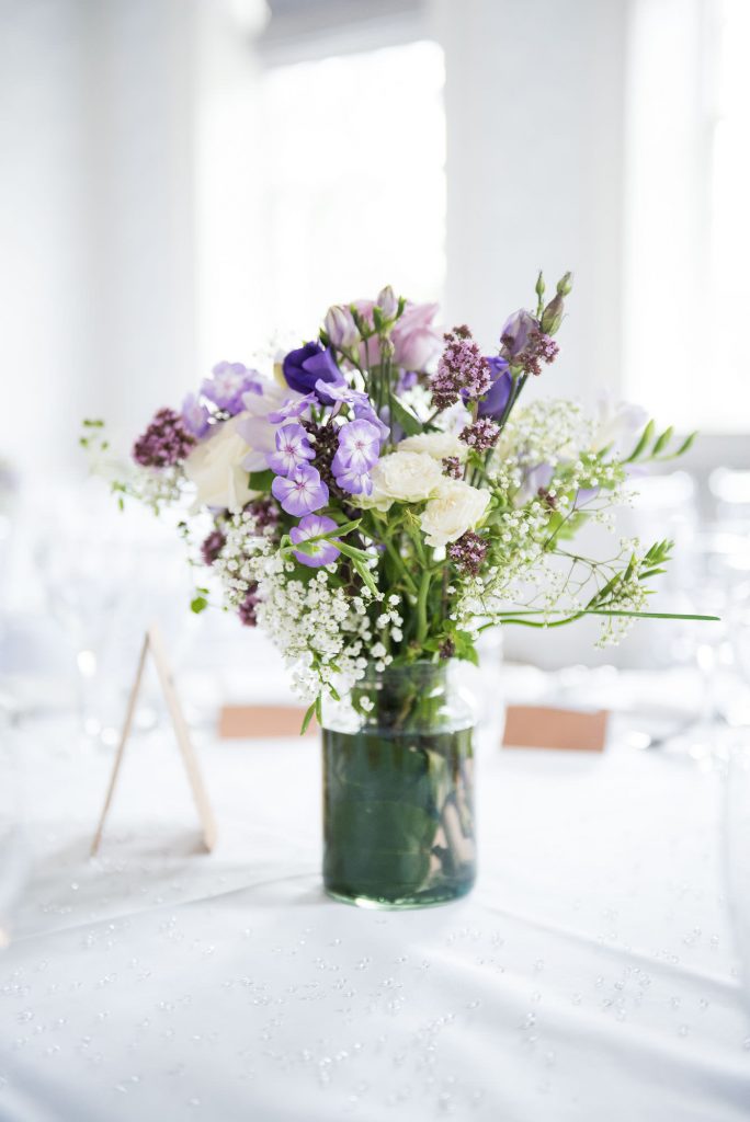 Purple floral arrangements by Wild Thyme Surrey wedding