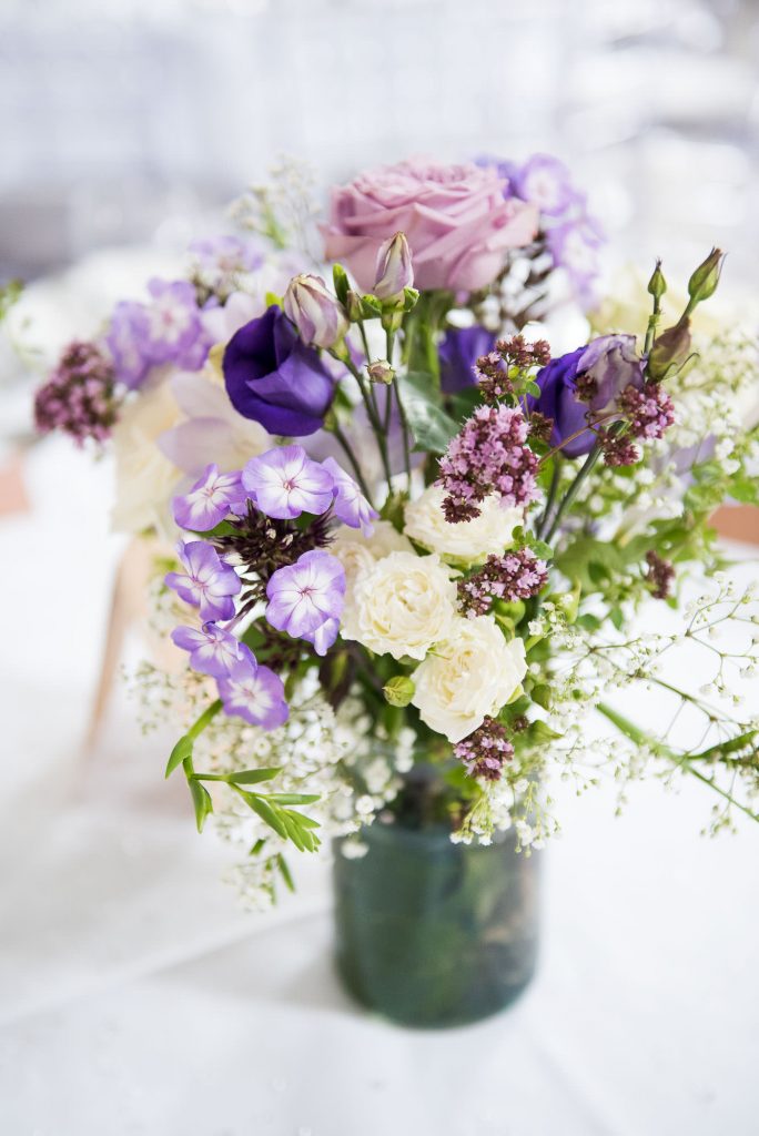 Purple floral arrangements by Wild Thyme Surrey wedding