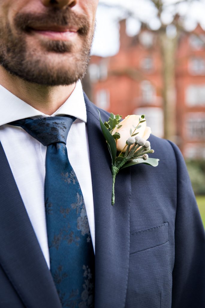 Navy blue suit with fresh white buttonhole London Wedding