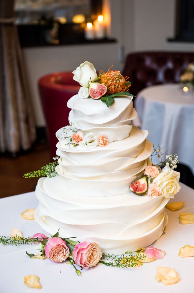 Stunning three tier white wedding cake with sugar decorations London