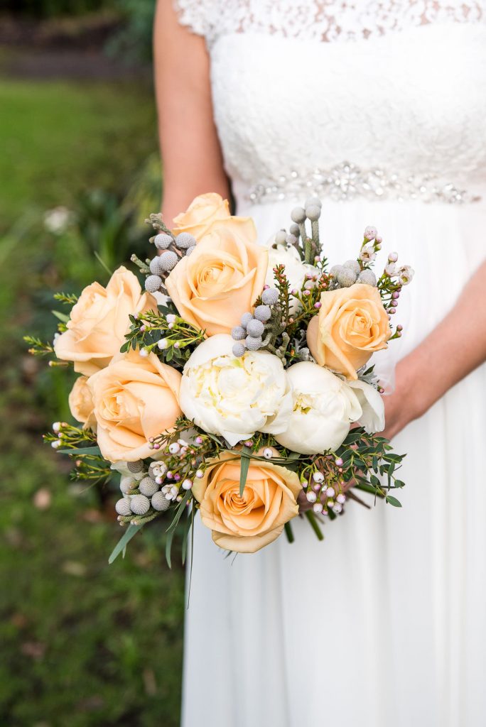 Fresh wedding bouquet with orange and white flowers