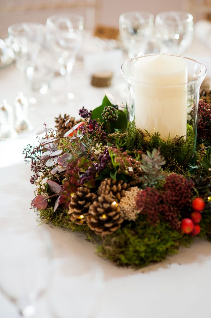Ashridge House Wedding. Natural Wedding Photography. Natural floral tone centre pieces with pine cones, winter berries and moss. 