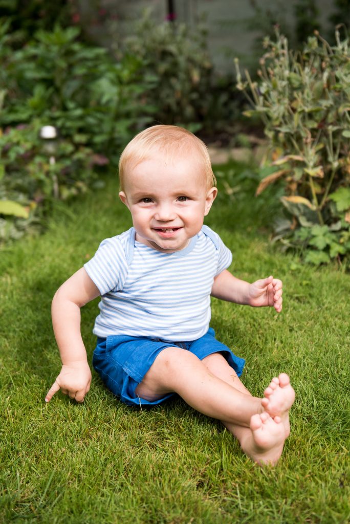 Naming Day Ceremony. Essex Family Photography. Fun and smiley baby in the garden. 