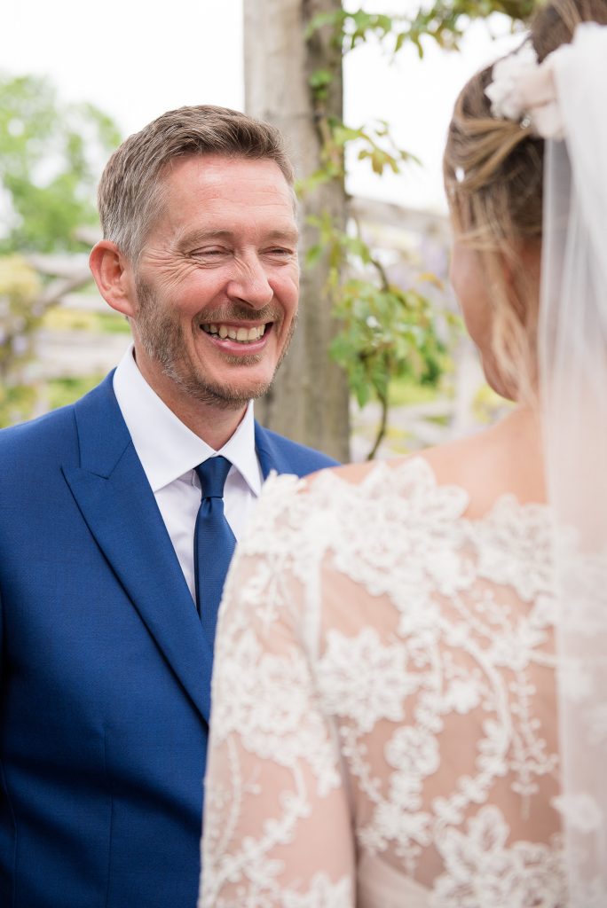 Great Fosters. Natural Documentary Wedding Photography, Surrey. Candid Moment Between Newlyweds in The Great Fosters Garden.