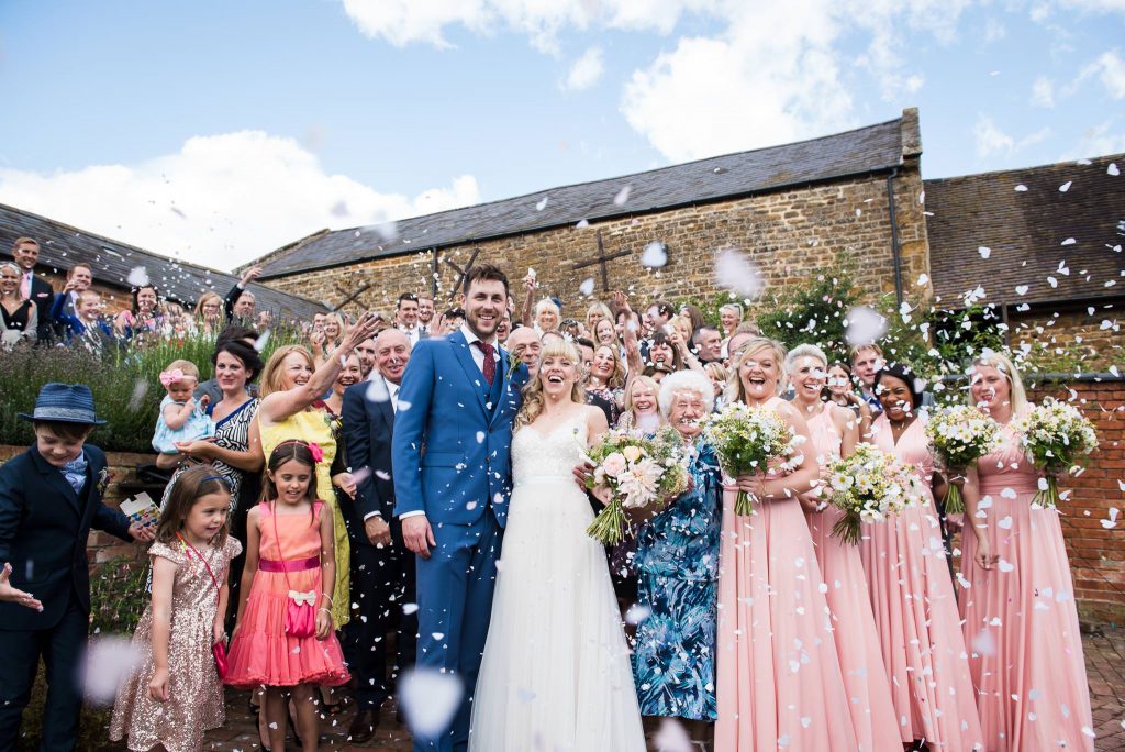 Wedding Confetti, Fun Documentary Wedding Photography Surrey, Couple Cheer as They Walk Down The Confetti Line
