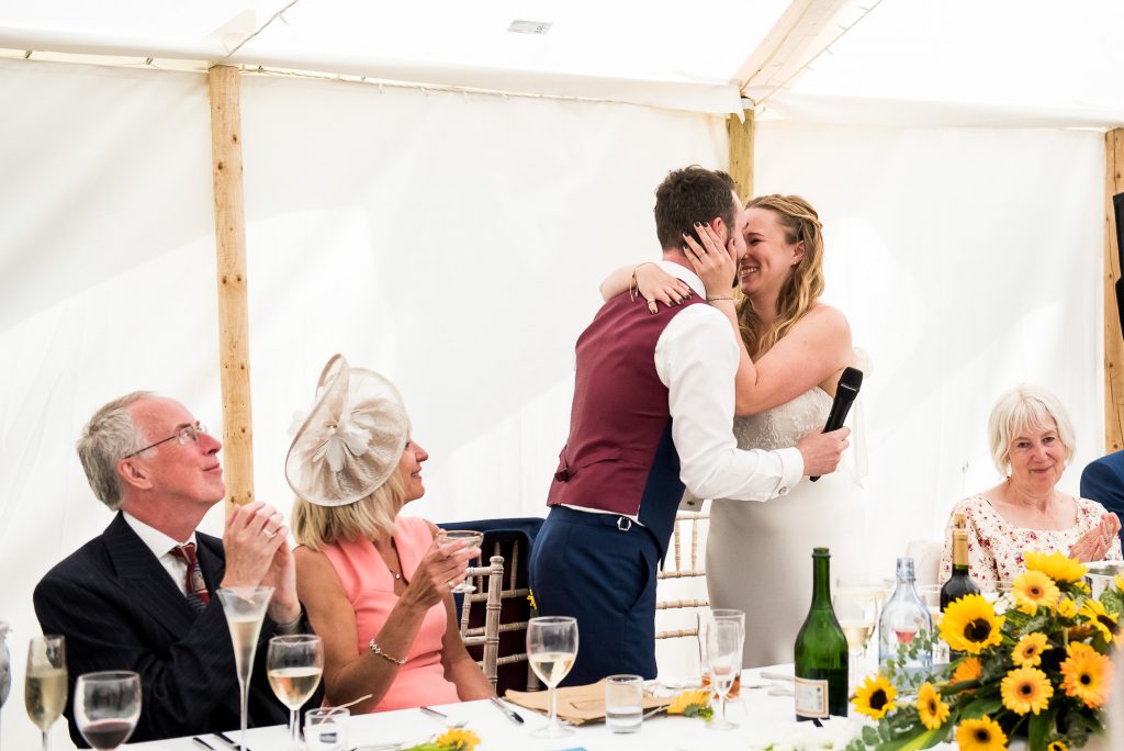 Wedding Day Timeline - Couple Embrace During Speeches - Outdoor Surrey Wedding
