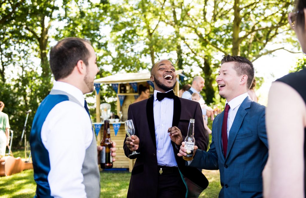 Wedding Day Timeline - Guests Enjoying Themselves and Laughing at Reception - Outdoor Surrey Wedding