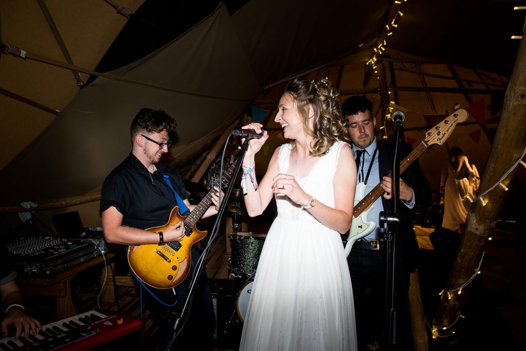 Inkersall Grange Farm Wedding - Same Sex Wedding Photography - Bride Singing With The Wedding Band