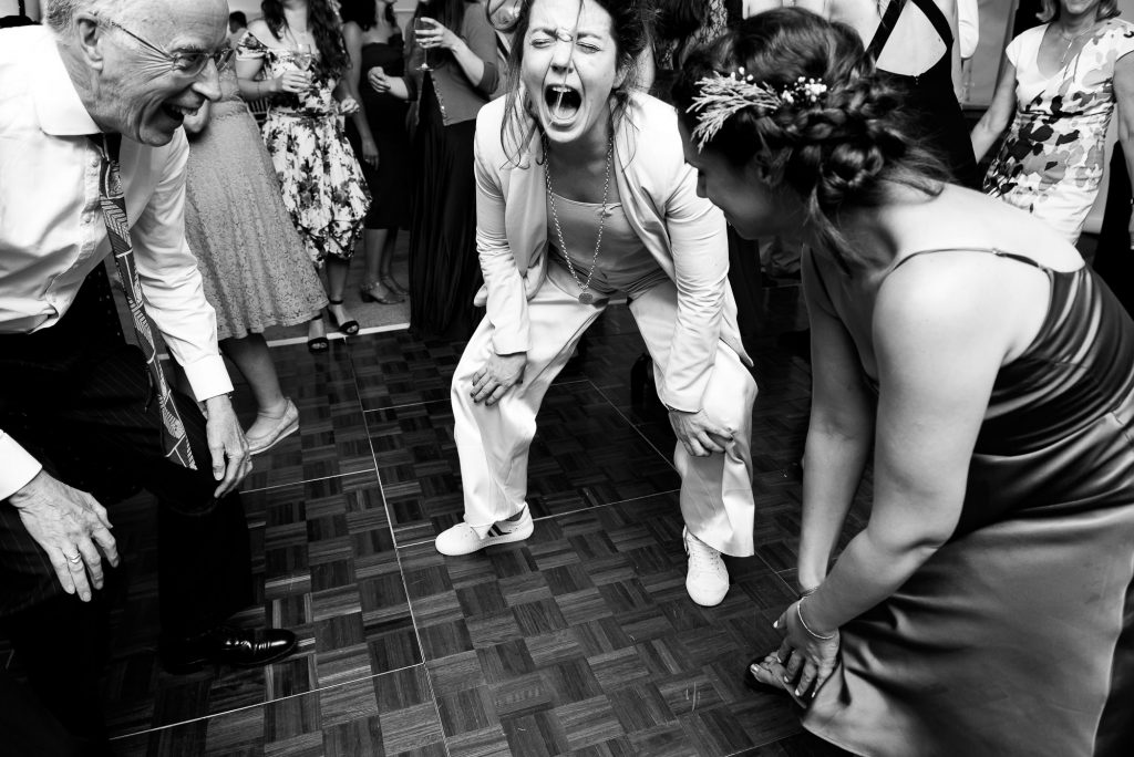 Outdoor Wedding Ceremony, Surrey Wedding Photography, Black and White Photograph Of Wedding Guest Energetically Dancing