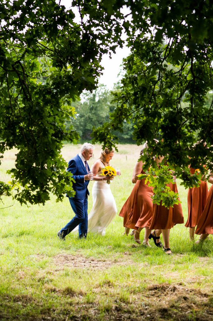 Bride Arrives To Her Outdoor Wedding With Father and Bridesmaids