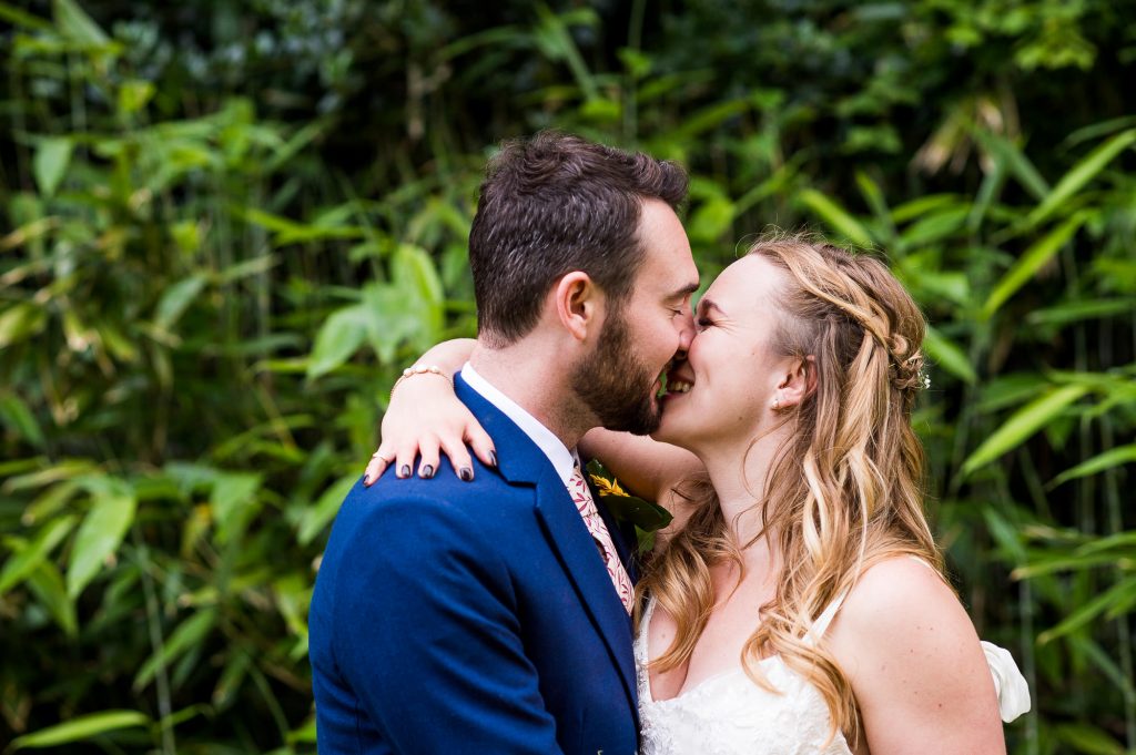 Bride and Groom Share a Kiss With Bamboo Forest Backdrop Surrey Wedding