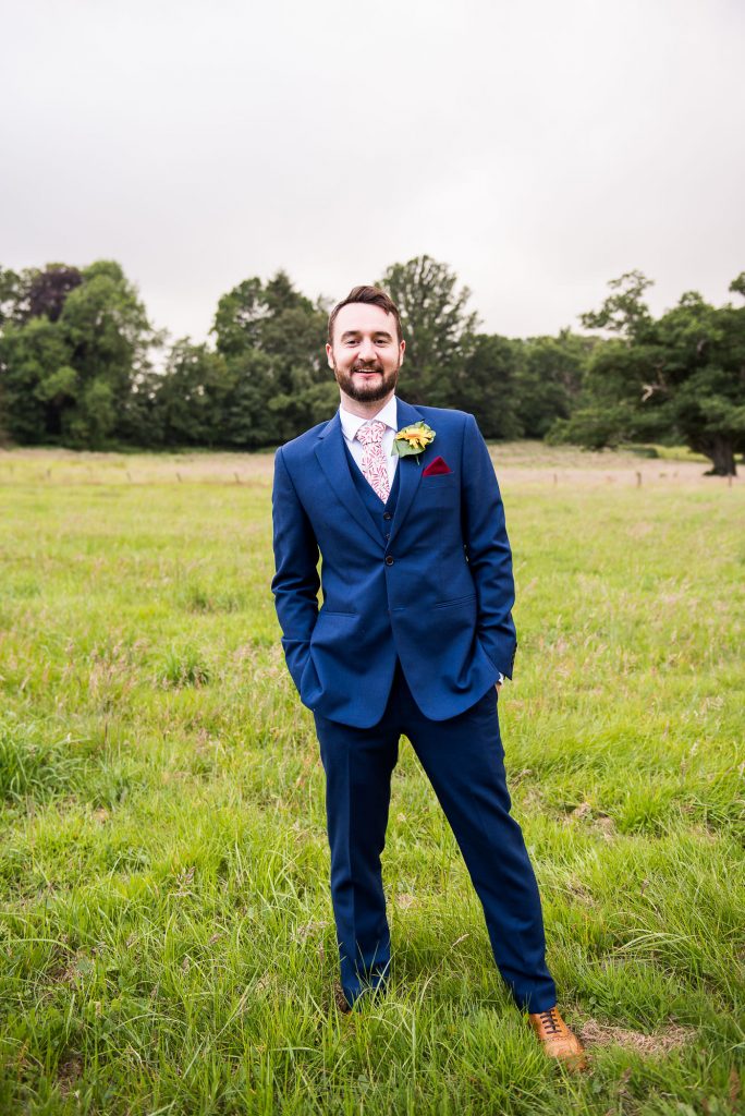 Handsome Groom In Three Piece Navy Blue Suit With Yellow Flower Button Hole