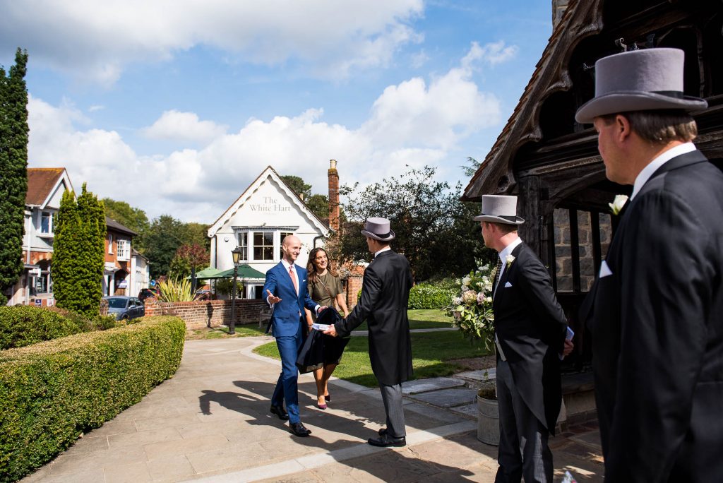 Outdoor Wedding Photography Surrey, Guests Arriving At Chobham Church In The Sunshine, Surrey Wedding Photography