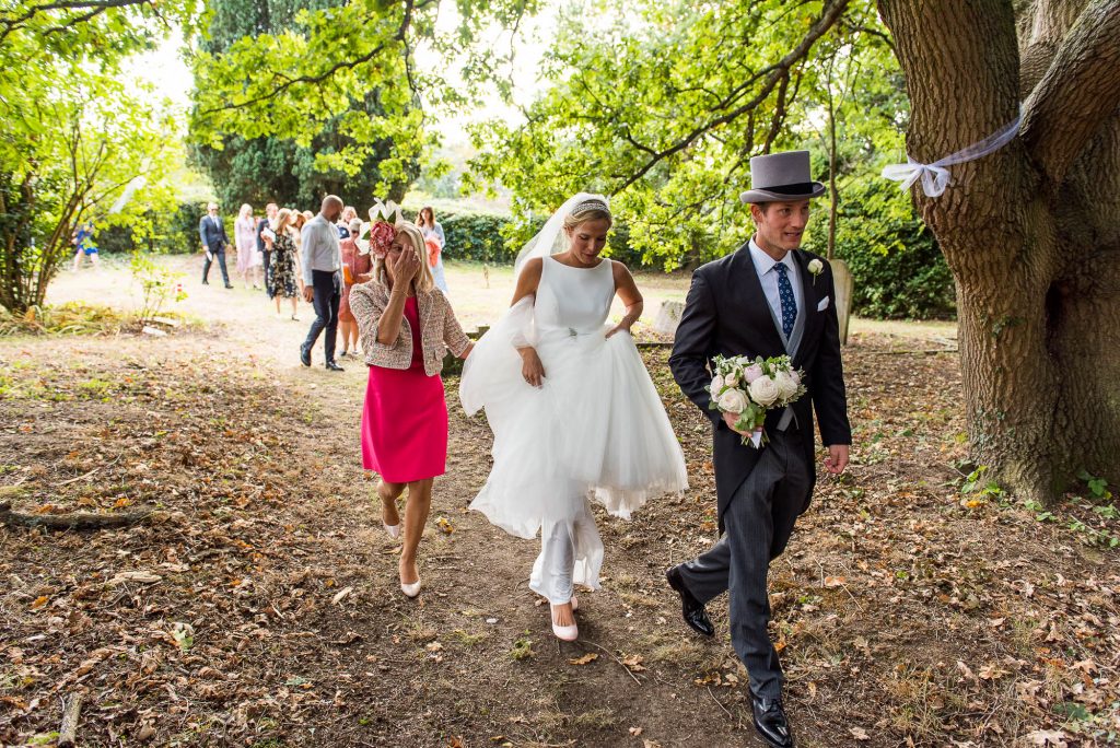 Outdoor Wedding Photography Surrey, Bride and Groom Walk Through Woodland To Get To The Garden Reception 