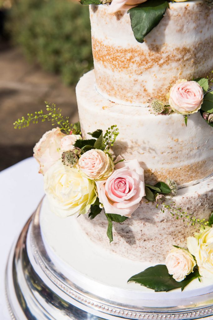 Outdoor Wedding Photography Surrey, Beautiful Three Tier Wedding Cake With White Icing and Fresh Flowers