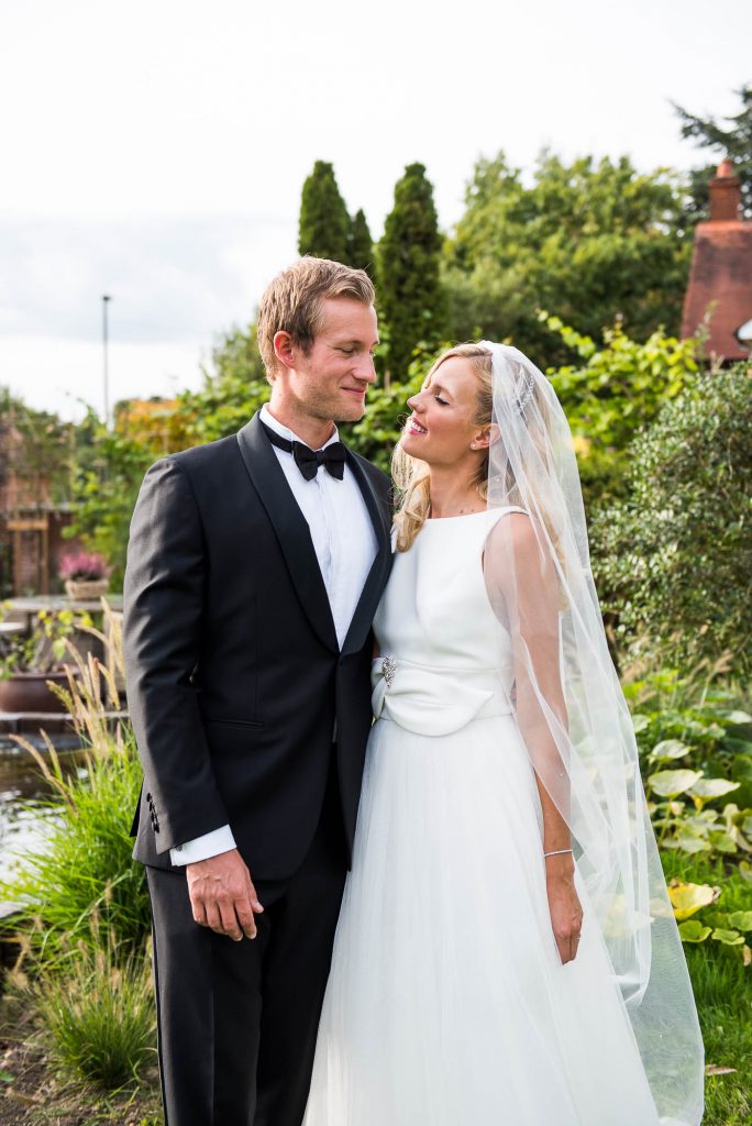 Outdoor Wedding Photography Surrey, Gorgeously Elegant Couple In Black Tie Stand For A Portrait