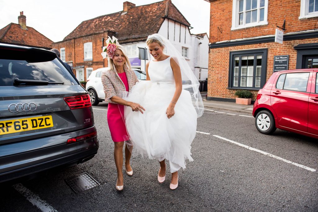 The Gorgeous Bride Wearing Jesus Piero Helped Out Of The Car By Her Mother, Surrey Wedding Photography