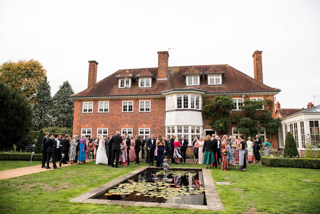 Outdoor Wedding Photography Surrey, Guests Gather For A Black Tie Wedding Reception At A Surrey House