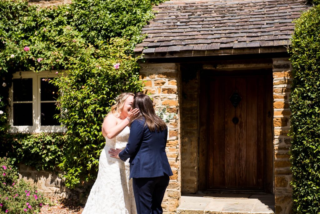 lgbt wedding photographer, Brides meet in the sunshine for an emotional first look