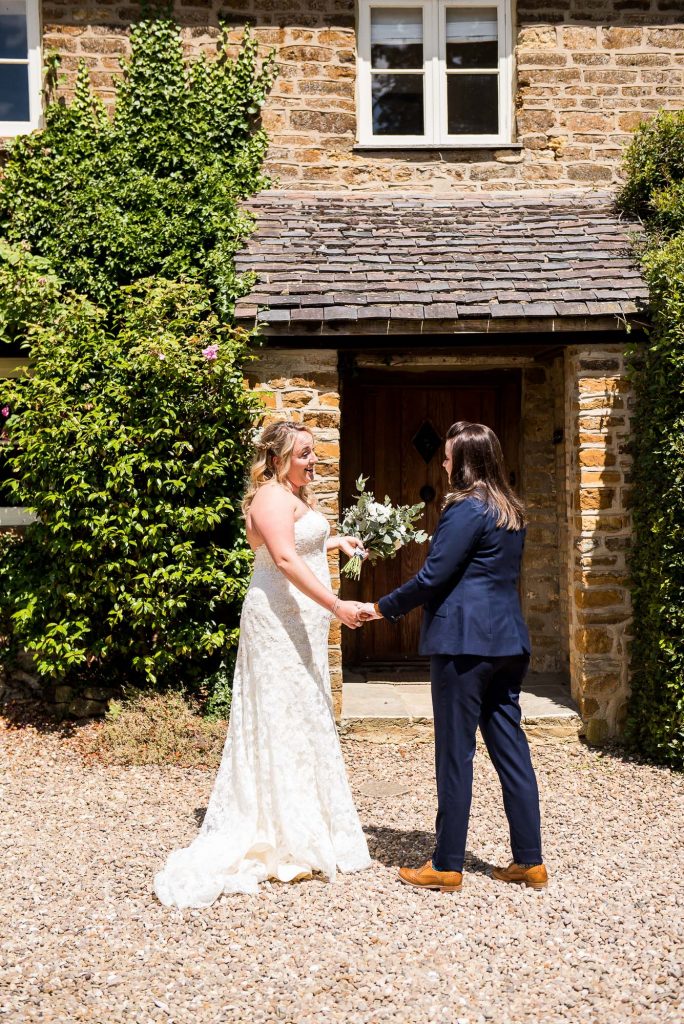 lgbt wedding photographer, Brides meet in the sunshine for their first look