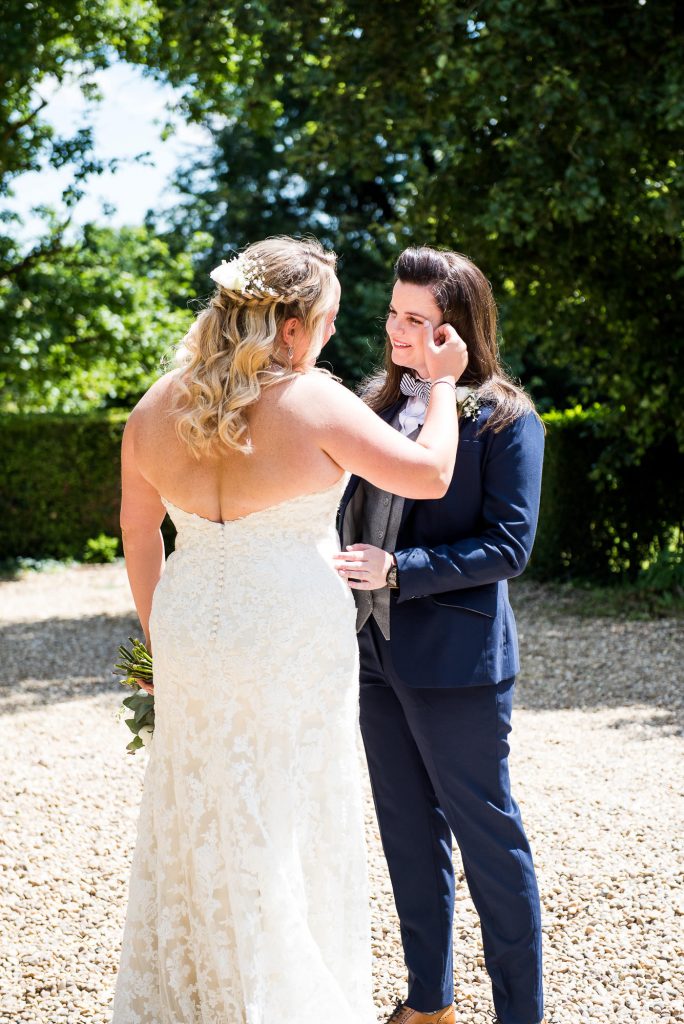 lgbt wedding photographer, Brides meet in the sunshine for an emotional first look
