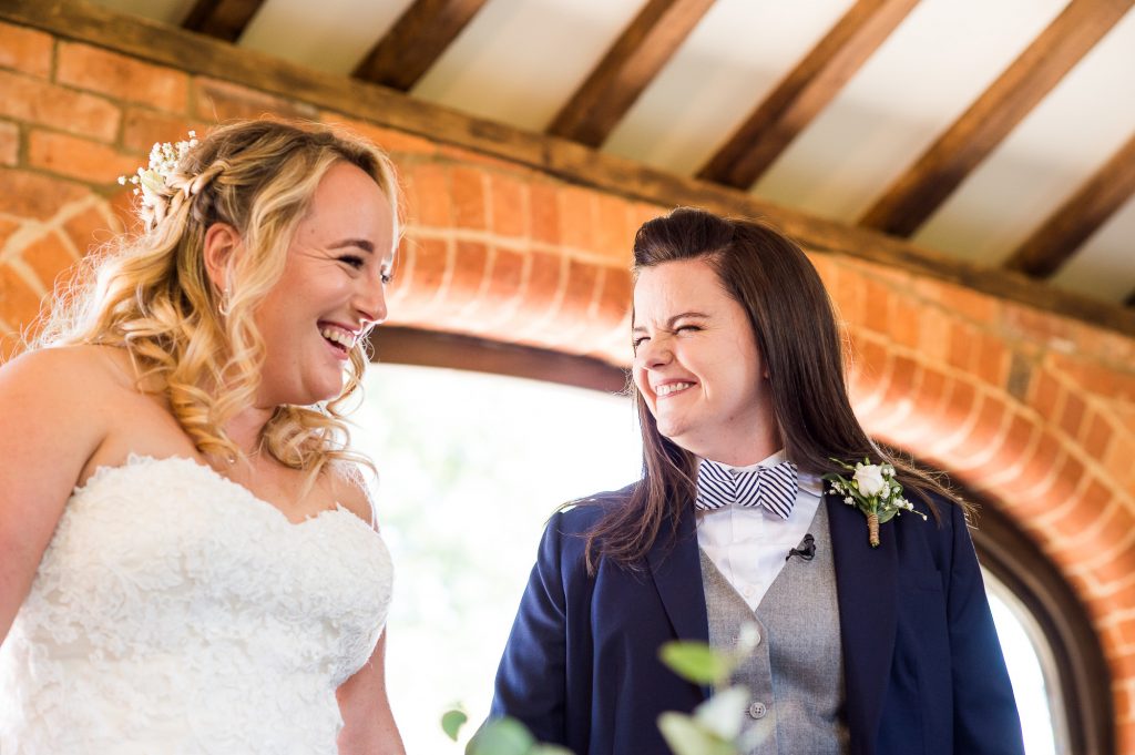 lgbt wedding photographer, Brides stare at each other lovingly with laughter