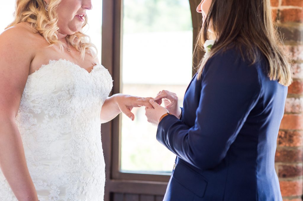 lgbt wedding photographer, brides exchange rings in same sex ceremony 