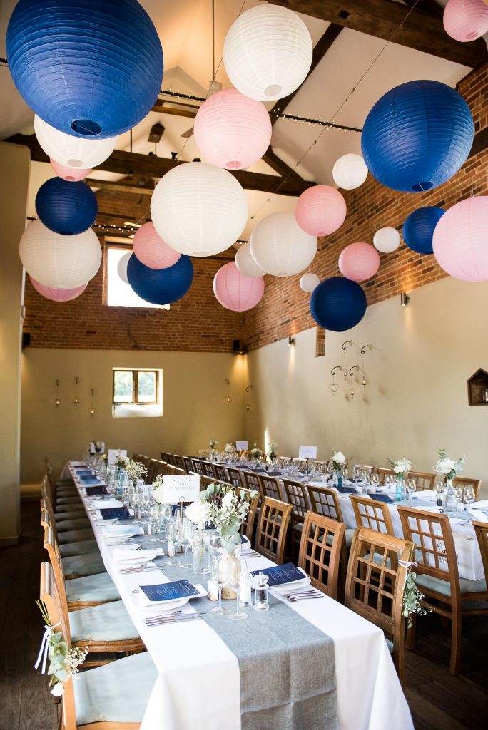 lgbt wedding photographer, wedding reception room decorated with assorted pastel paper lanterns 
