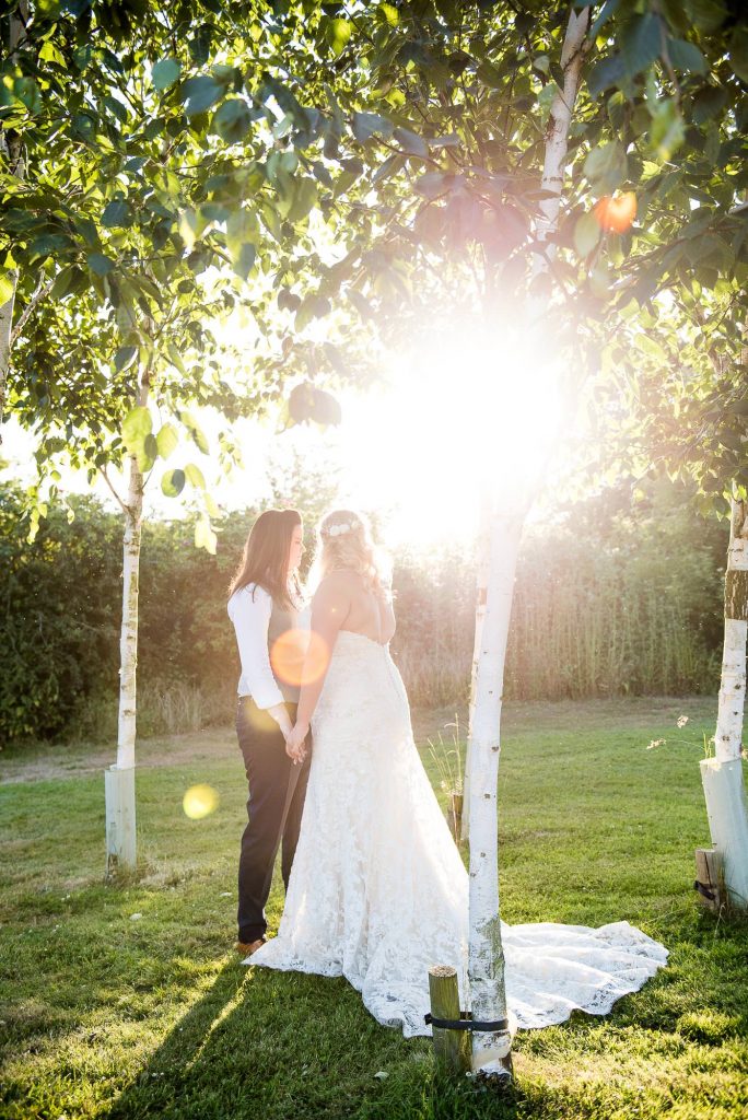 lgbt wedding photographer, same sex couple embrace each other at golden hour