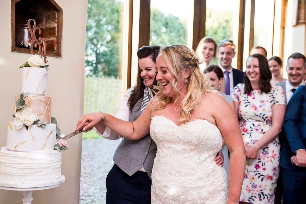 lgbt wedding photographer, brides cut the cake together, Dodmoor House Wedding