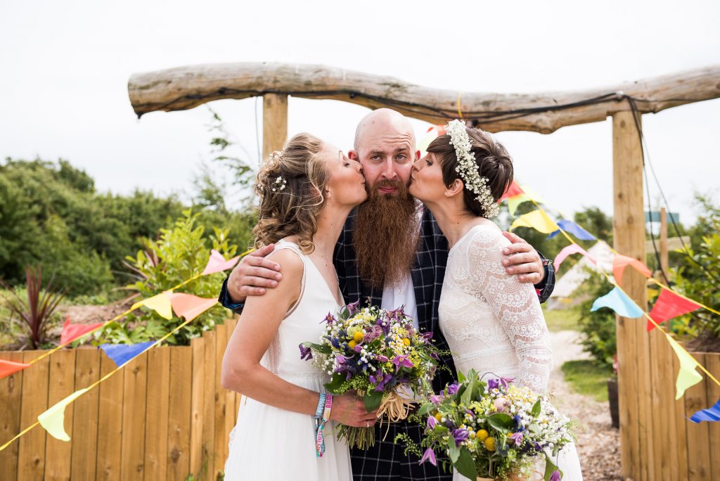 creative wedding photography surrey, brides kiss their best man on the cheeks, LGBT wedding photographer