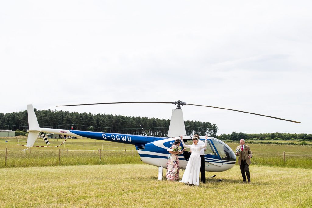 LGBT wedding photography, bride arrives in a wedding helicopter