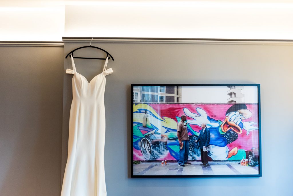 Old Marylebone Town Hall Wedding, Wedding dress hanging in an artistic room at the Andaz Hotel