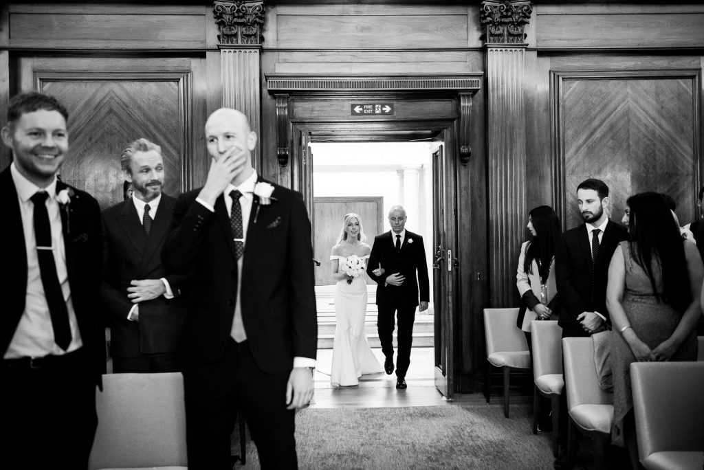 Old Marylebone Town Hall Wedding, groom's reaction as bride walks down the aisle