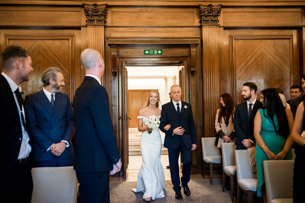 Old Marylebone Town Hall Wedding, groom's reaction as bride walks down the aisle 