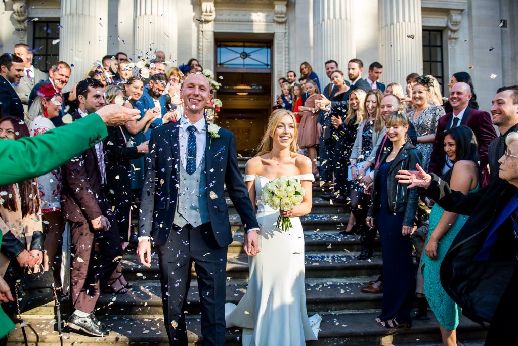 Old Marylebone Town Hall Wedding, stylish bride and groom exit their wedding to confetti line, London wedding