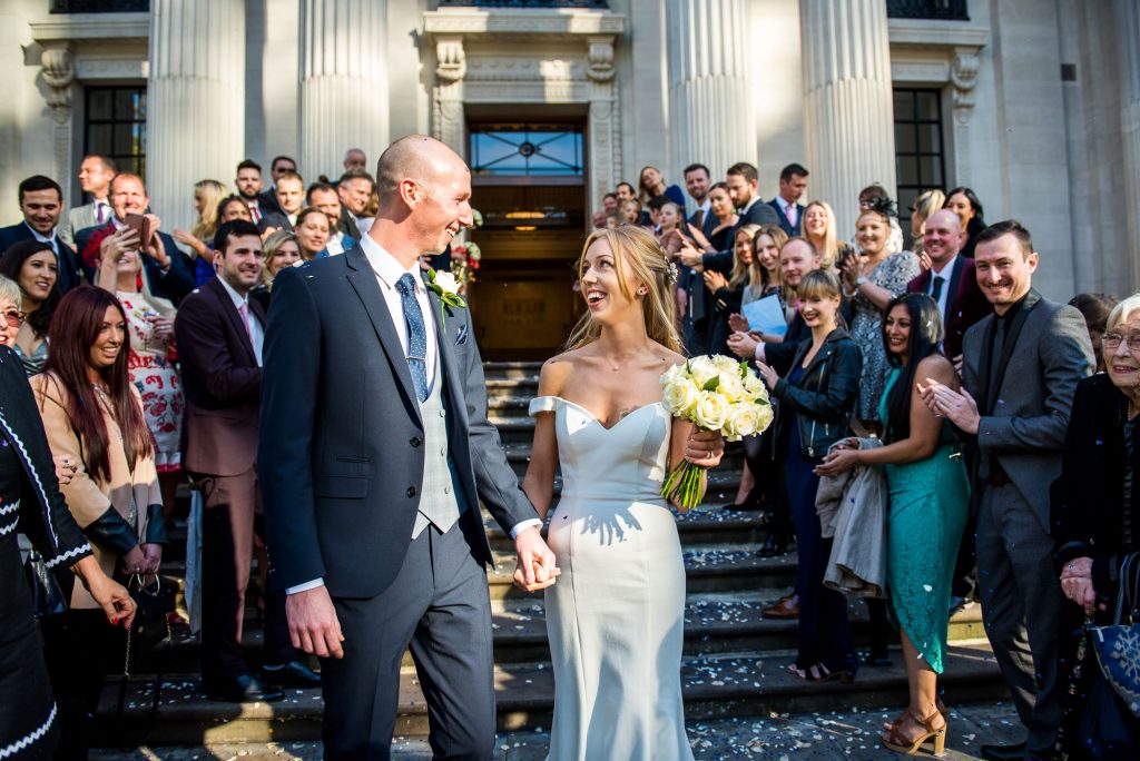 Old Marylebone Town Hall Wedding, stylish bride and groom exit their wedding to confetti line, London wedding